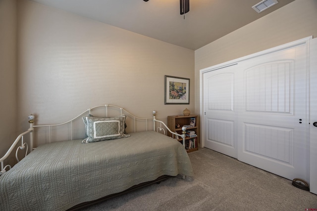 bedroom featuring a closet, ceiling fan, and carpet