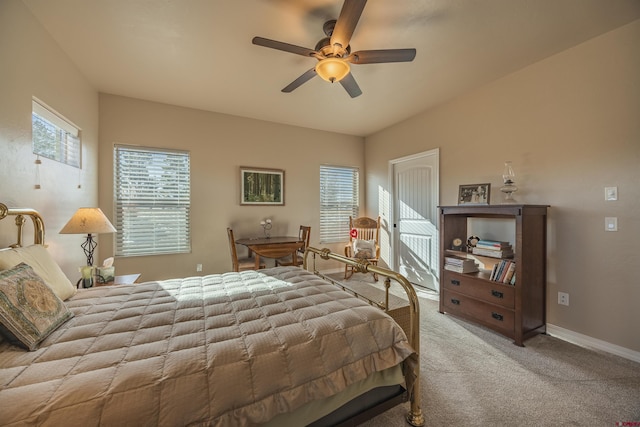 bedroom featuring ceiling fan, light colored carpet, and multiple windows