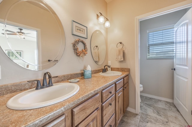 bathroom featuring vanity, ceiling fan, and toilet