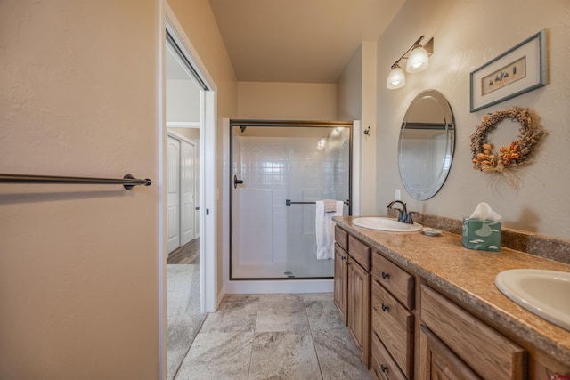 bathroom featuring vanity and an enclosed shower