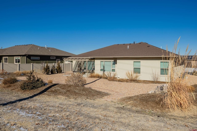 rear view of property with a pergola