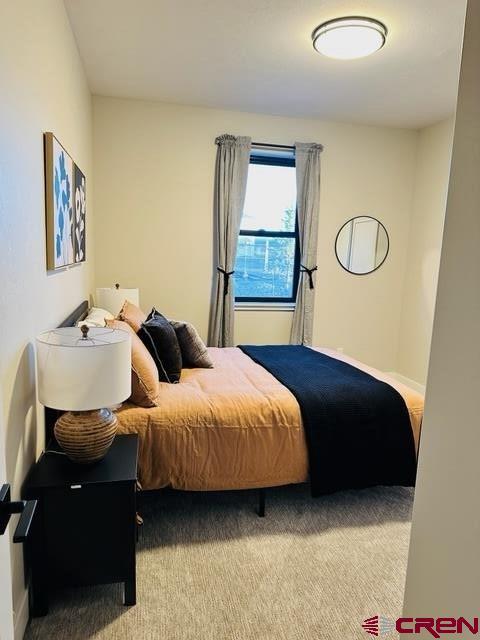 bedroom featuring light colored carpet