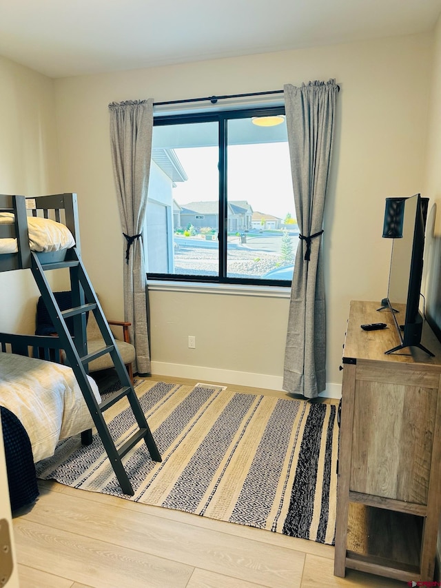 bedroom featuring hardwood / wood-style flooring and multiple windows