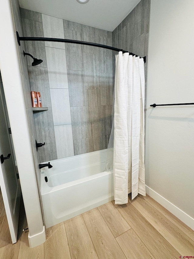 bathroom featuring hardwood / wood-style flooring and shower / tub combo