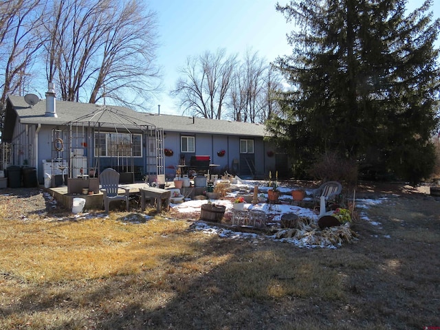 back of house featuring a gazebo and a lawn