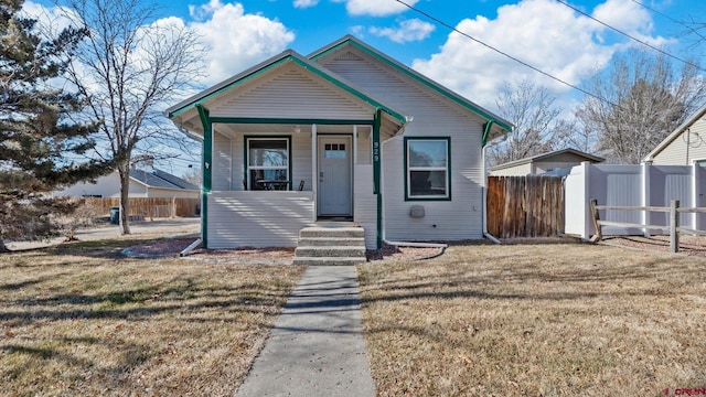 bungalow-style house featuring a porch and a front lawn