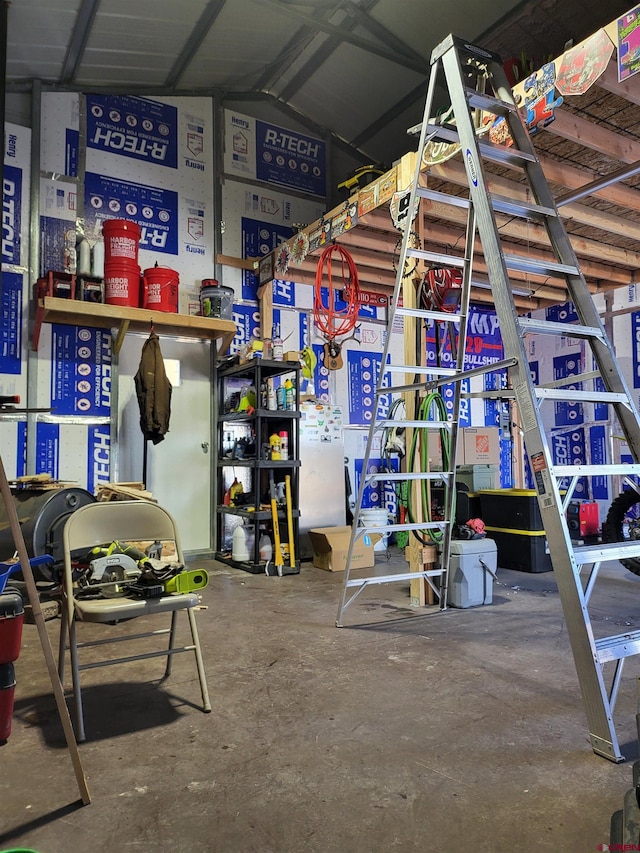 interior space featuring vaulted ceiling and concrete floors