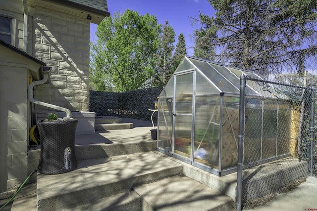 620 Tillotson St, Trinidad, CO 81082 - view of patio / terrace with a greenhouse, fence, and an outdoor structure