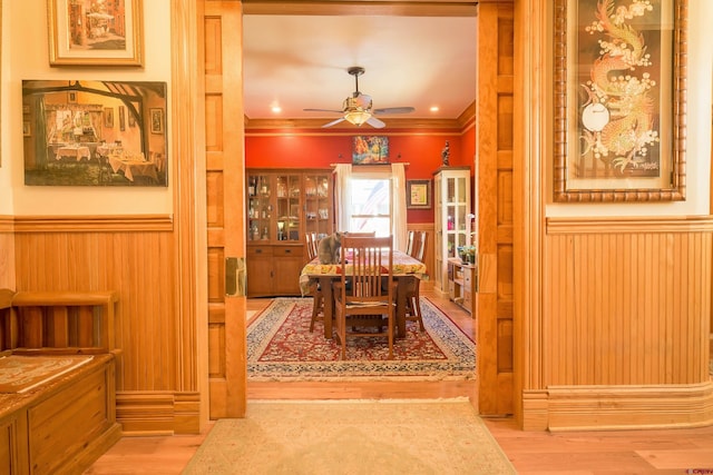 dining area with crown molding, ceiling fan, and light hardwood / wood-style floors