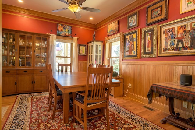 dining space featuring crown molding, ceiling fan, and light wood-type flooring