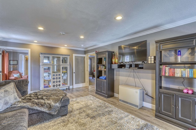 interior space with crown molding, a textured ceiling, and light hardwood / wood-style floors