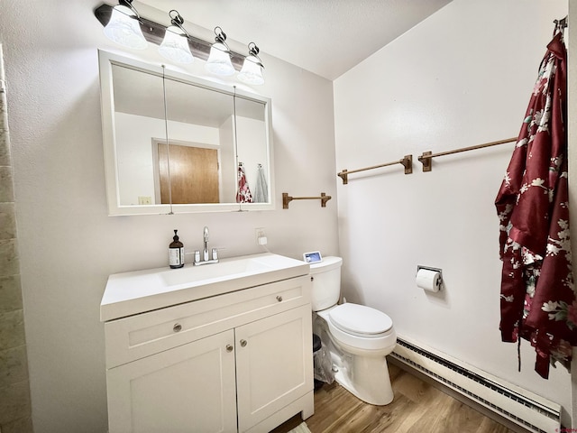 bathroom featuring vanity, hardwood / wood-style floors, toilet, and baseboard heating