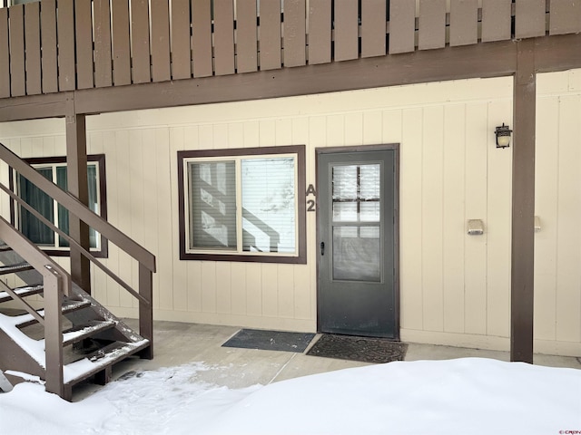 view of snow covered property entrance