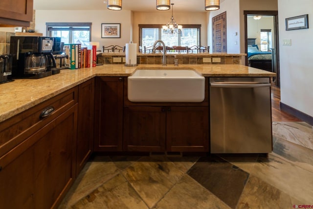 kitchen with dishwasher, sink, a chandelier, hanging light fixtures, and light stone countertops