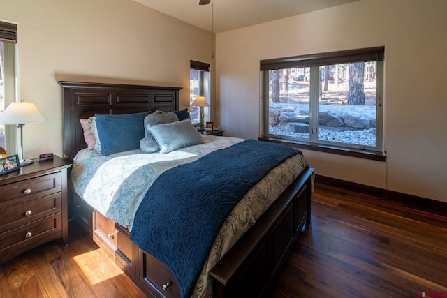 bedroom with dark wood-type flooring and ceiling fan