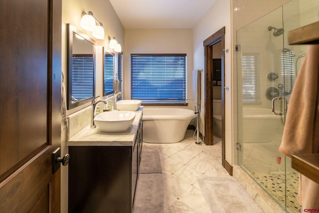 full bathroom featuring vanity, plus walk in shower, and toilet