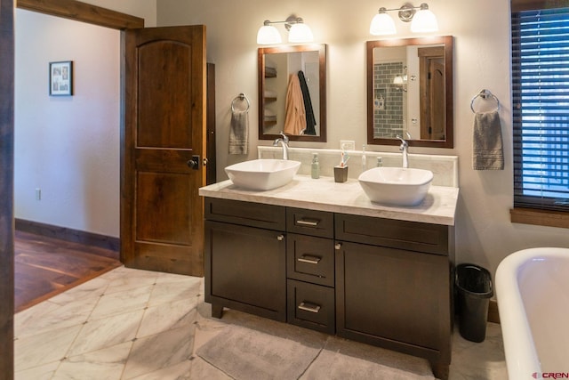 bathroom featuring vanity and a washtub