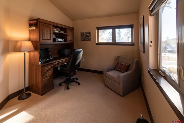 carpeted office space featuring vaulted ceiling