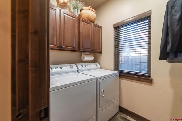 laundry room with washer and clothes dryer and cabinets