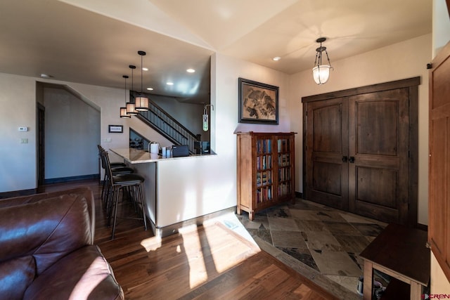 entryway with dark hardwood / wood-style flooring and vaulted ceiling