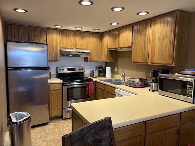 kitchen with stainless steel appliances, light tile patterned flooring, sink, and kitchen peninsula