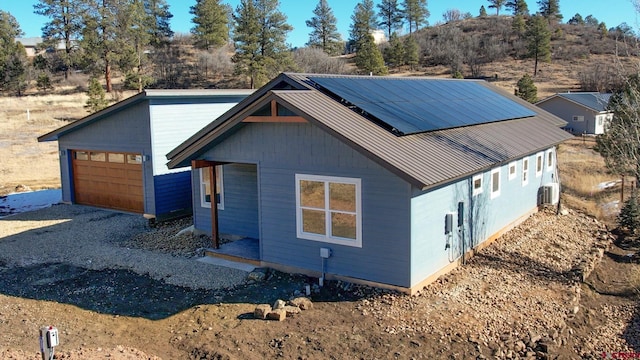 view of front of house featuring a garage and solar panels