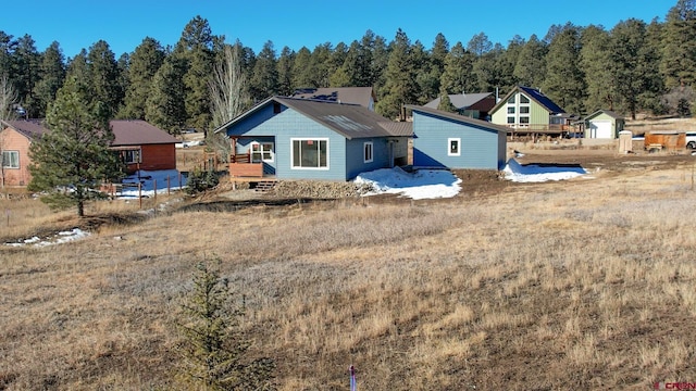 rear view of property featuring a wooden deck