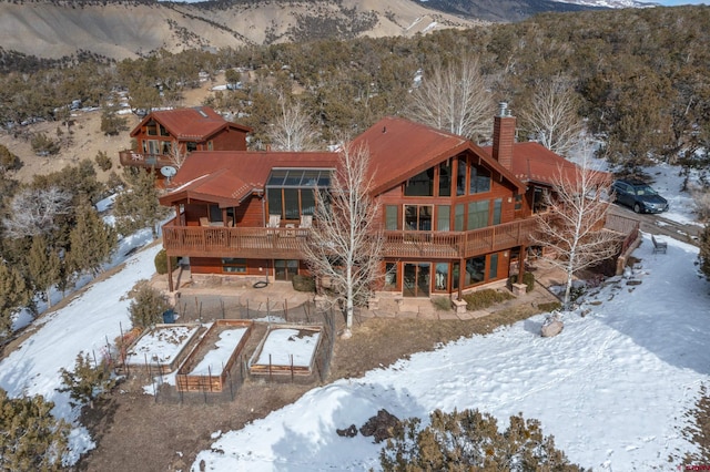 snowy aerial view with a mountain view