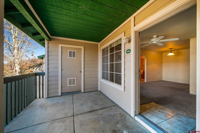 doorway to property featuring a balcony and ceiling fan