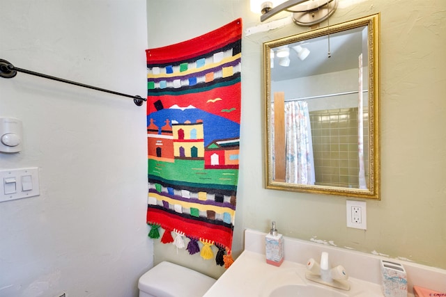 bathroom with vanity, curtained shower, and toilet