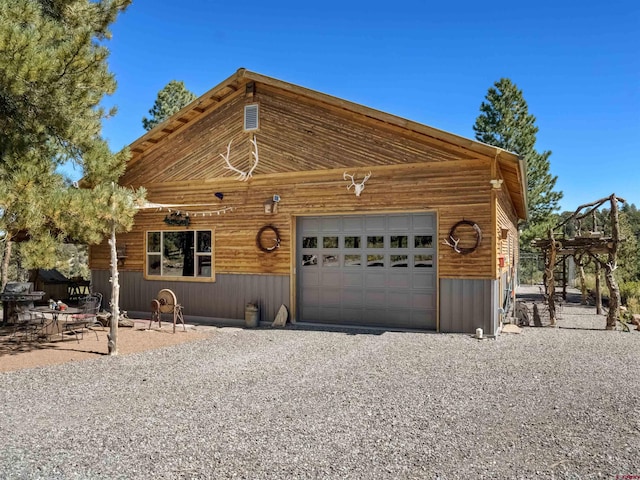 log home featuring a garage