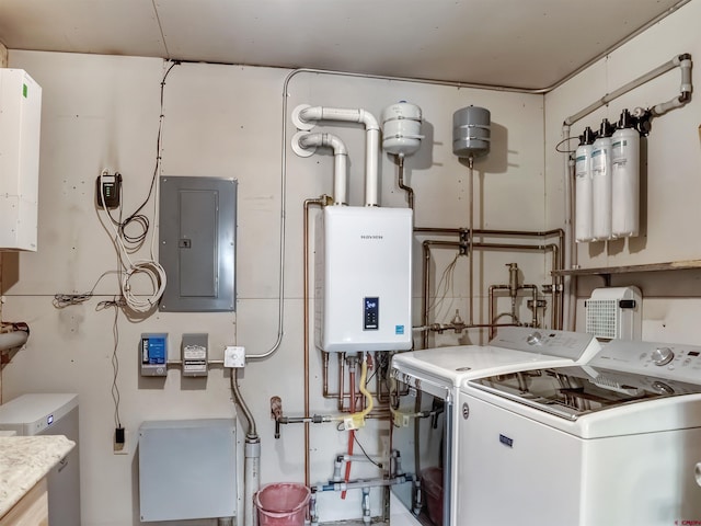 utility room with water heater, electric panel, and washer and dryer