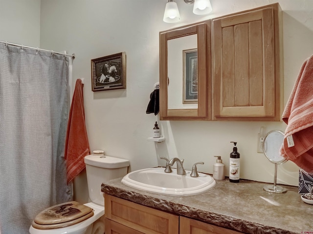 bathroom featuring vanity, a shower with shower curtain, and toilet