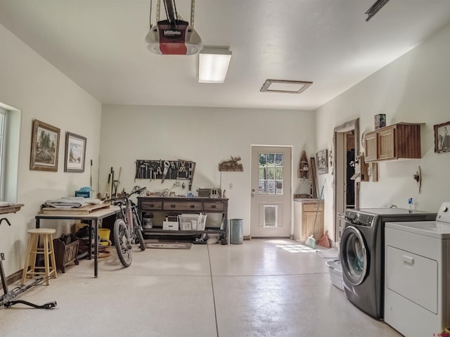 garage with a garage door opener and washing machine and clothes dryer