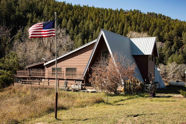 view of side of property with a yard