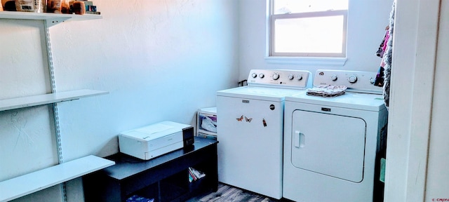 washroom featuring hardwood / wood-style flooring and washing machine and dryer