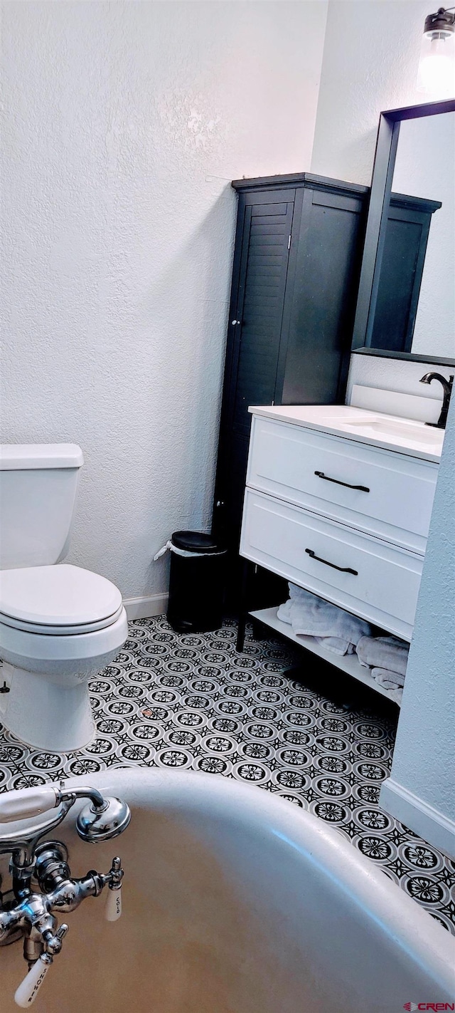 bathroom featuring vanity, toilet, and tile patterned flooring