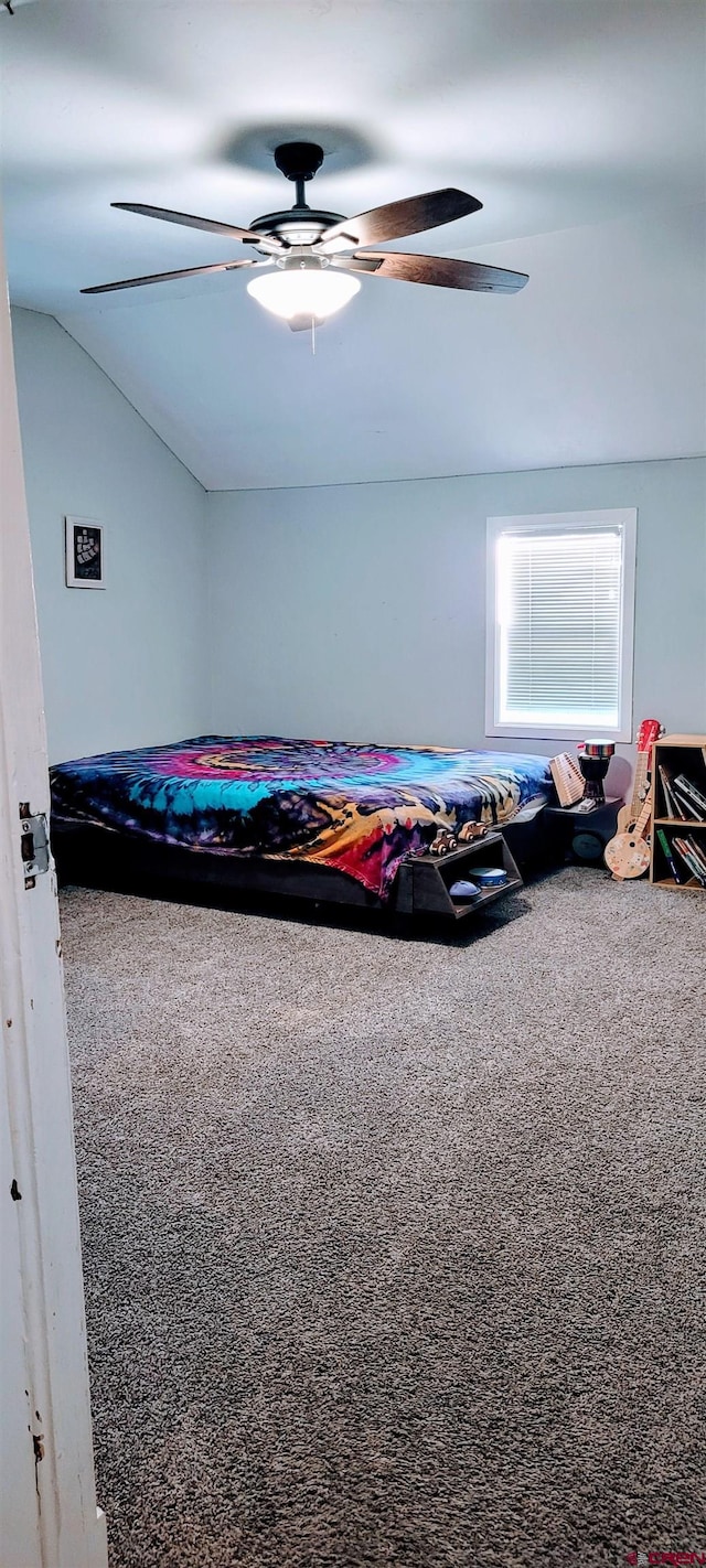 bedroom with lofted ceiling, carpet floors, and ceiling fan