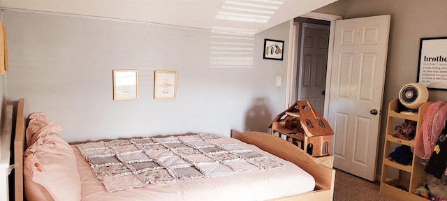 carpeted bedroom featuring vaulted ceiling