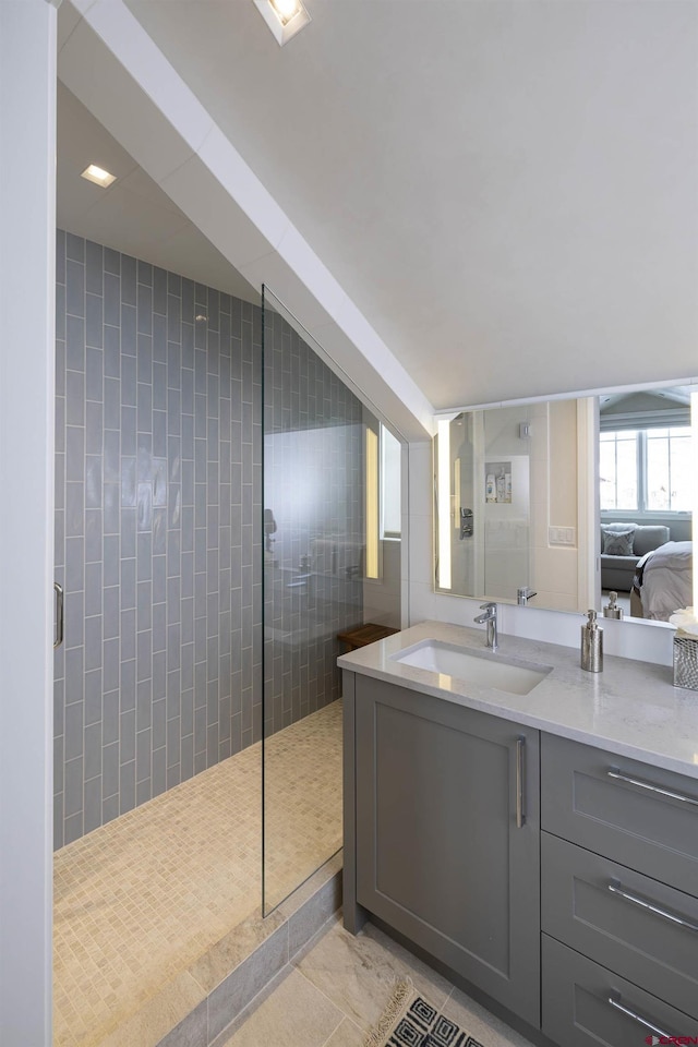 bathroom featuring tile patterned flooring, vanity, and walk in shower