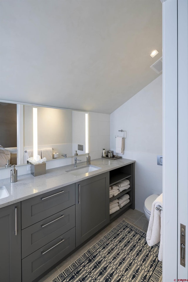 bathroom featuring vanity, tile patterned floors, and toilet