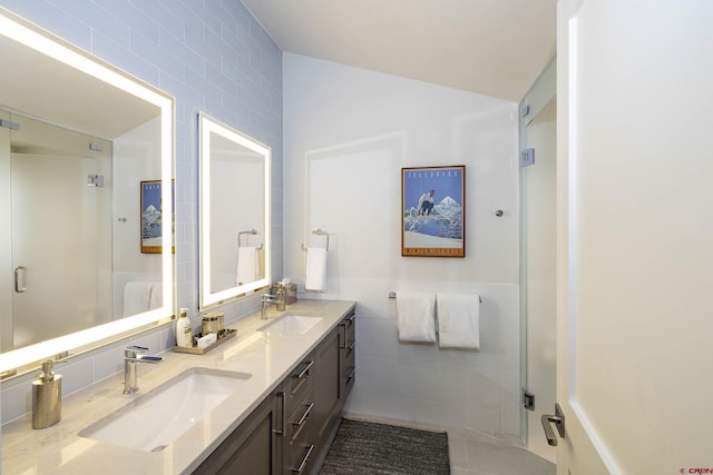 bathroom with tile walls, vanity, and tile patterned flooring