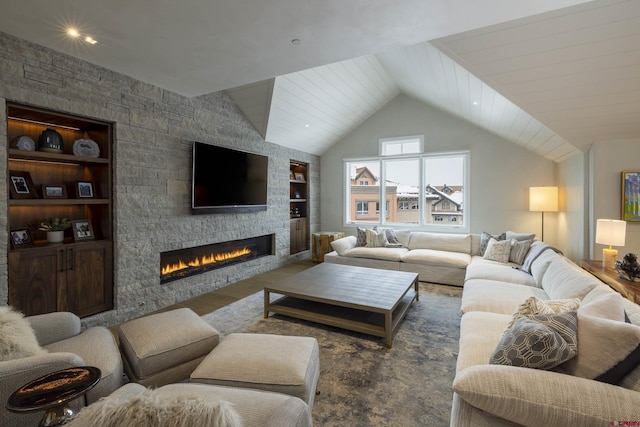 living room featuring a fireplace, vaulted ceiling, and built in features