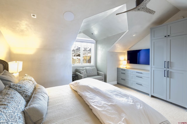 bedroom featuring vaulted ceiling, light colored carpet, and ceiling fan