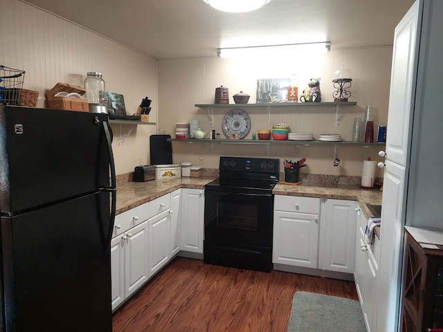 kitchen with dark wood-type flooring, white cabinetry, stone countertops, and black appliances