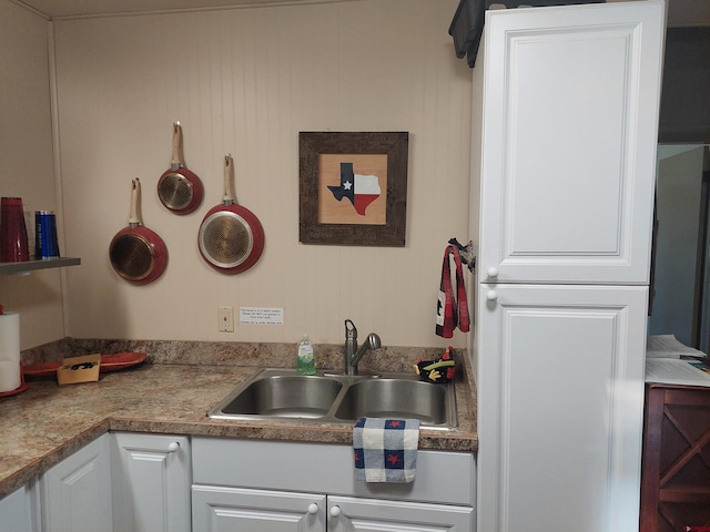 kitchen featuring white cabinetry and sink