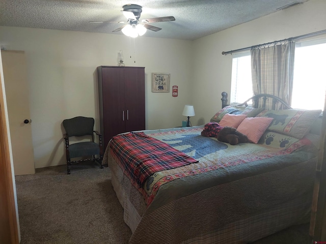 carpeted bedroom with a textured ceiling and ceiling fan