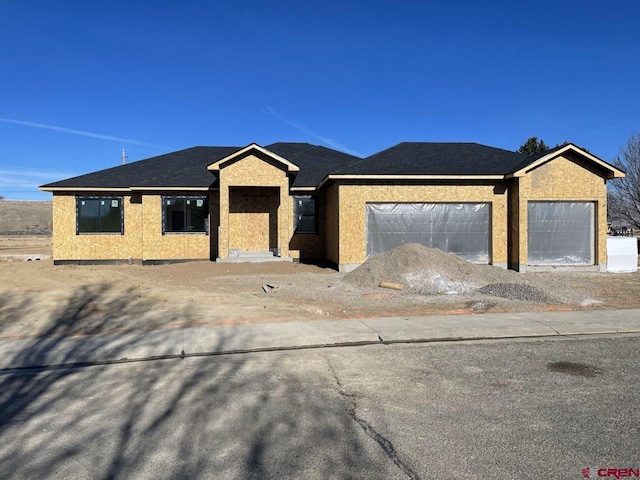 view of front facade with a garage and stucco siding