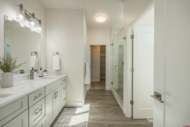 bathroom with vanity, hardwood / wood-style floors, and an enclosed shower