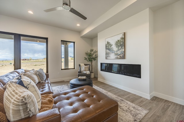 living room featuring hardwood / wood-style flooring and ceiling fan